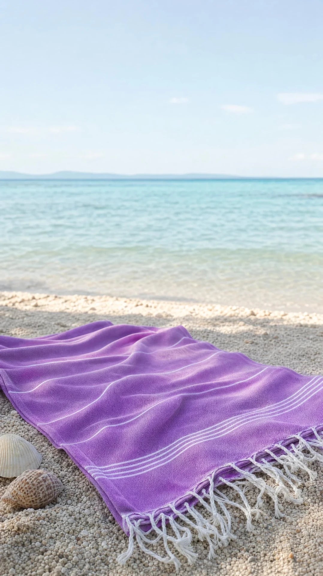 Lilac peshtemal spread on a pebble beach